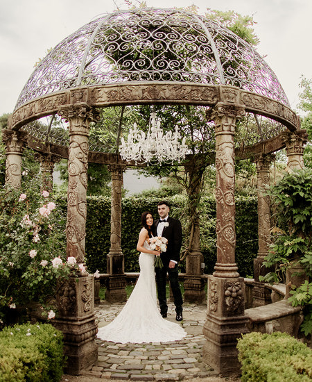 Newlywed couple stand inside garden pavillion at ballyseeded country estate and castle