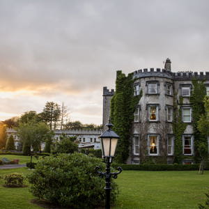 Sunsets at ballyseeded castle hotel as newlywed couple embrace
