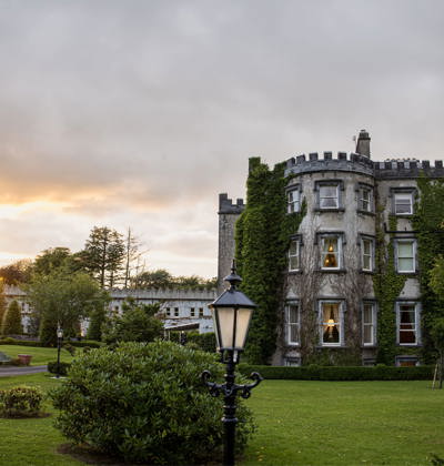 Sunsets at ballyseeded castle hotel as newlywed couple embrace