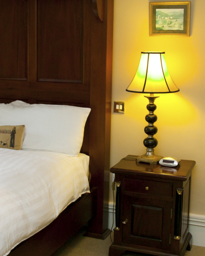 Bedside table and bed in hotel suite in kerry