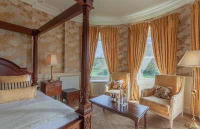 Gold wall paper in luxury castle hotel room in ireland