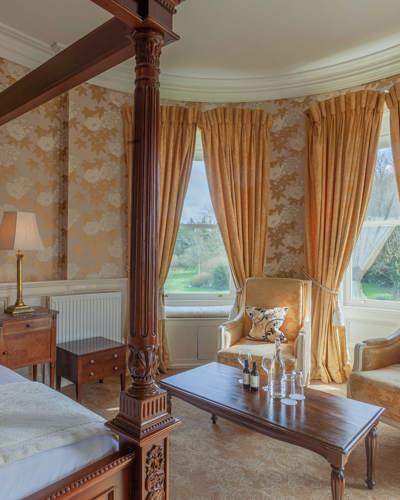 Gold wall paper in luxury castle hotel room in ireland