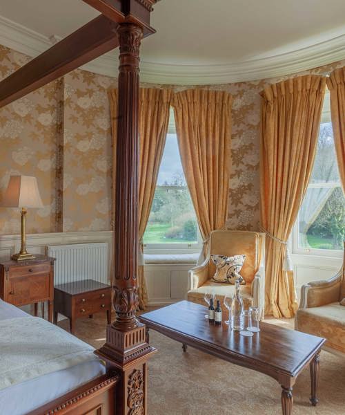 Gold wall paper in luxury castle hotel room in ireland
