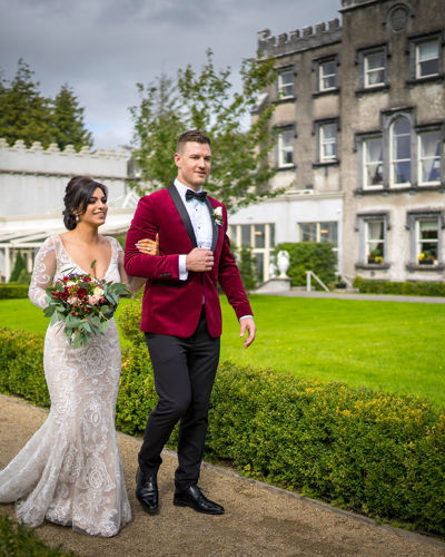 Bride and groom walking through the country estate gardens at castle estate ireland