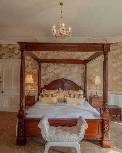 Luxury castle hotel room in ireland with timber bed and estate views