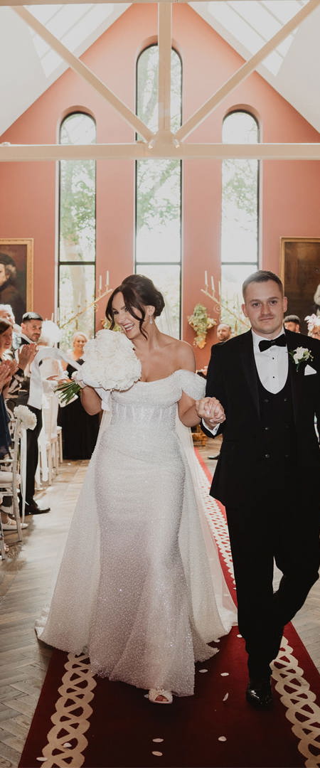 Couple walk down the aisle on their wedding day at irish castle wedding venue