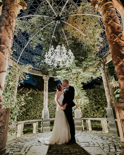 Couple kiss in the garden pavillion on the ballyseede castle estate in kerry
