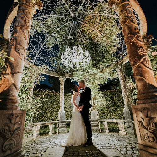 Couple kiss in the garden pavillion on the ballyseede castle estate in kerry