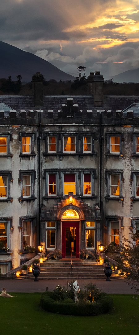 Ballyseede castle hotel at dusk exterior view with lights 
