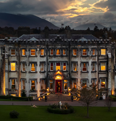 Ballyseede castle hotel at dusk exterior view with lights 