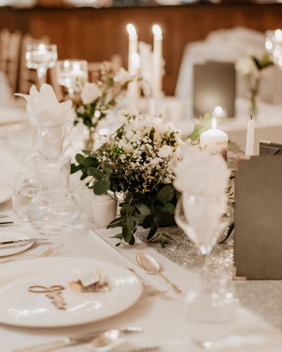 Exquisite wedding reception place settings on white tablecloth at kerry castle wedding venue