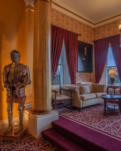 Traditional irish castle interior with knights armour and chadelier in drawing room