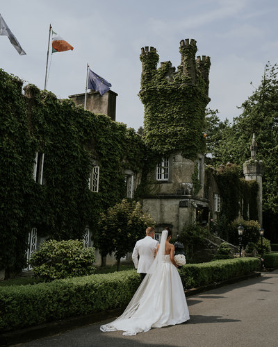 Newlyweds walking through the ballyseede country estate gardens