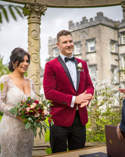 Couple stand at the altar on their wedding day at ballyseede castle wedding venue