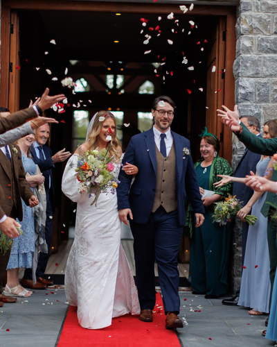 Guests celebrate wedding as couple walk down aisle at irish hotel wedding venue in kerry