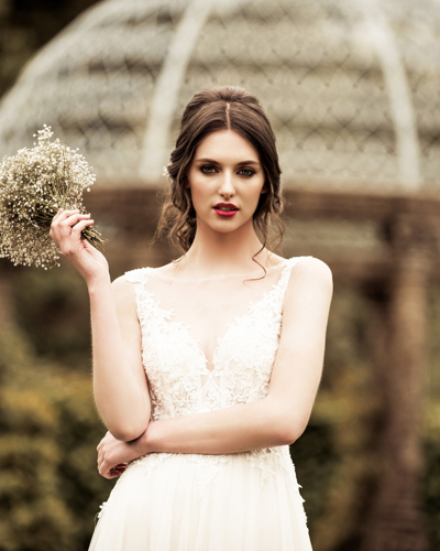 Bride holding bouquet in country estate garden at ballyseede hotel