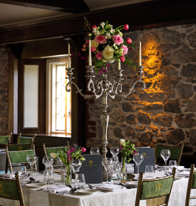 Large silver candlestick holdere on wedding reception table in irish wedding venue