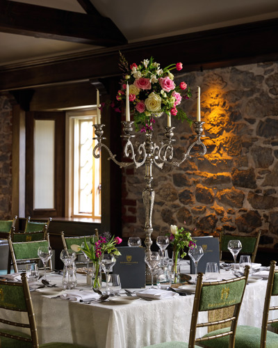 Large silver candlestick holdere on wedding reception table in irish wedding venue