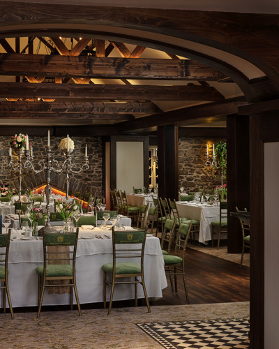 Country estate wedding reception venue with wooden beams and high ceilings