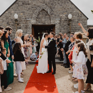 Guests celebrate as couple kiss on their wedding day